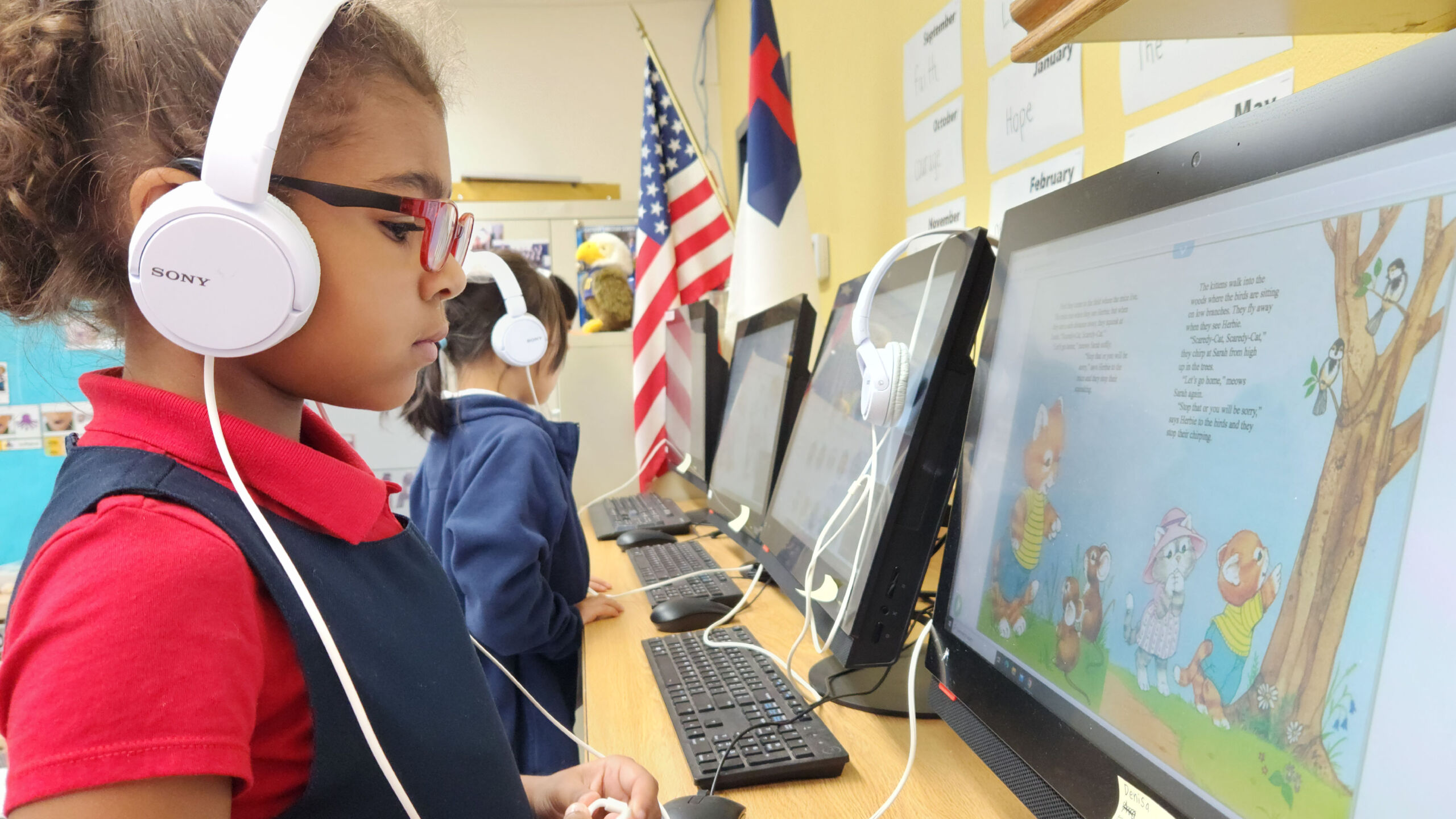 k students standing at computers-01